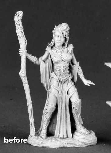 a photo of a miniature. She is a woodelf wearing a loincloth and bikinitop, holding a staff