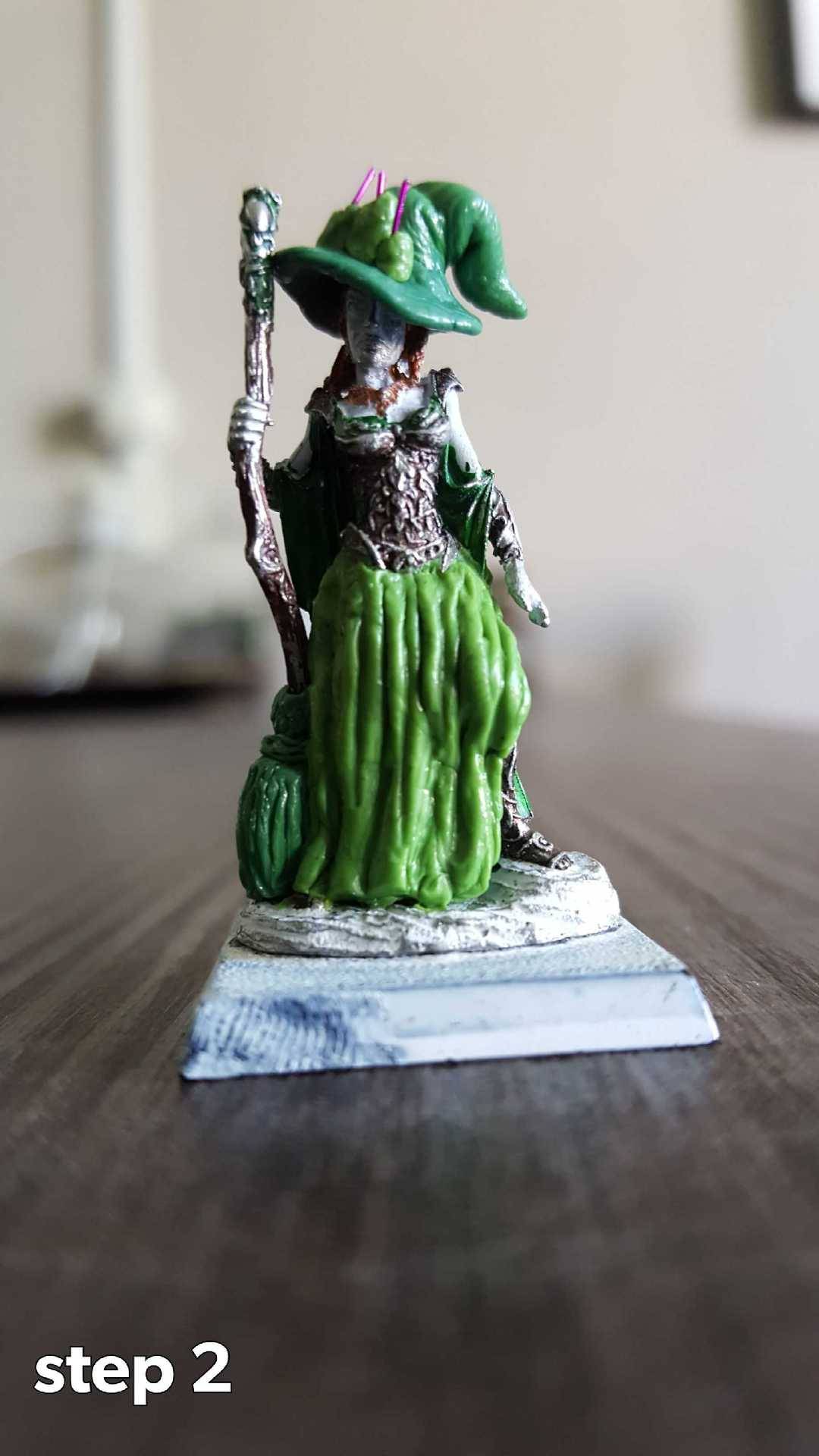 the same mini, but with greenstuff the staff is changed into a broom, the loincloth into a skirt, and she now has a hat with candles on the brim.
