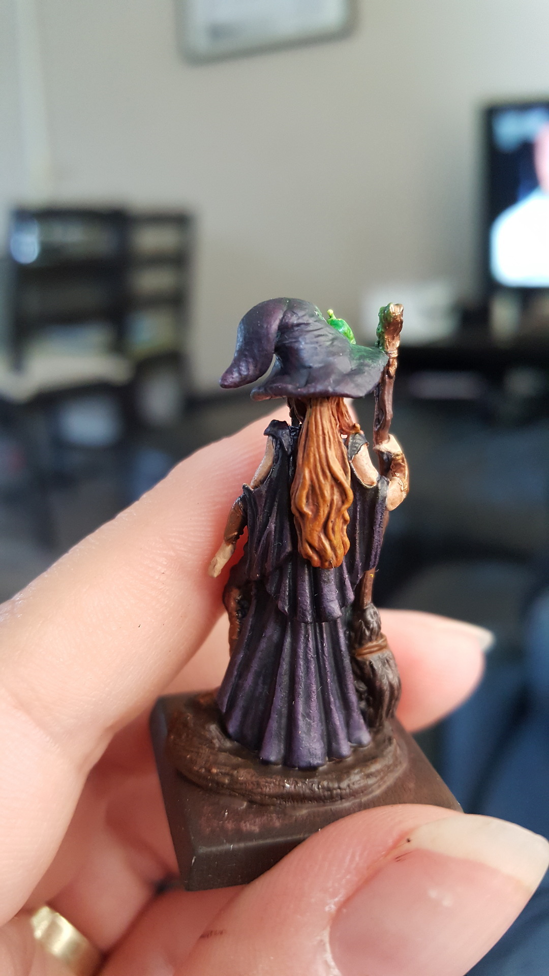 back view of the mini now painted. The fabric is all in purples and her hair is light brown.