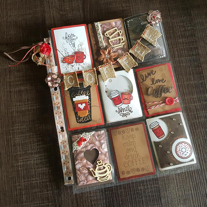 A pocket letter laying open, displaying nine small cards in reds and browns. A small bunting made of burlap is attached to the front, which says coffee.